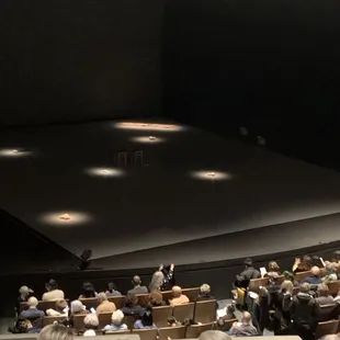 a crowd of people sitting in chairs
