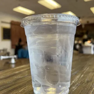 a clear plastic cup on a wooden table