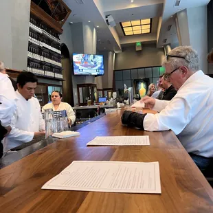 a group of people sitting at a bar