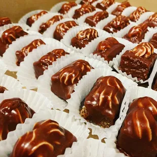 a tray of chocolate covered desserts