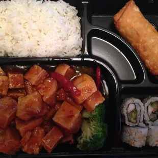 General Tso&apos;s tofu dinner box with a California roll and an egg roll