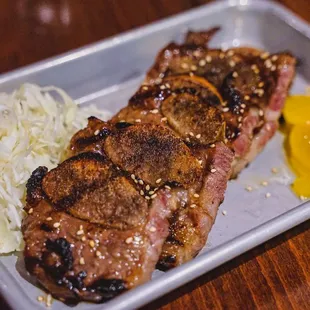 a large piece of steak on a bed of sauerkraut
