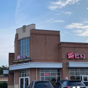 two cars parked in front of a restaurant