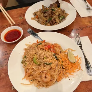 two plates of food on a wooden table