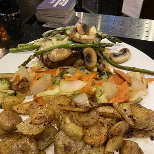 Filet Mignon with asparagus, mushrooms, sautéed veggies and fried potatoes. Twice as good and half the price as a famous steak house.