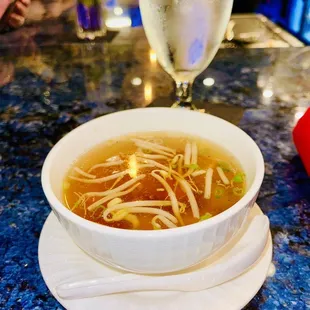 a bowl of soup and a glass of wine