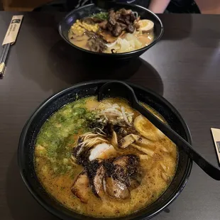 One bowl of spicy black garlic ramen (front) and one zen ramen in the back.