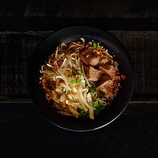Anonymous Ramen: beef stew in spicy beef broth with Thai chili, lime, sweet basil, onions, sprouts