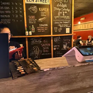 a woman sitting at a counter with a laptop