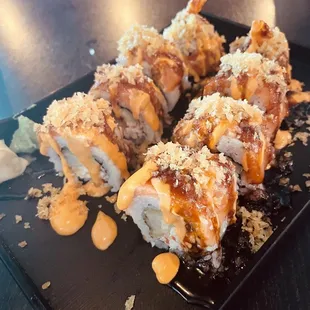 a sushi roll on a black plate