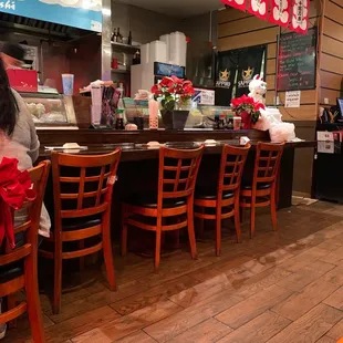 a little girl sitting at the bar