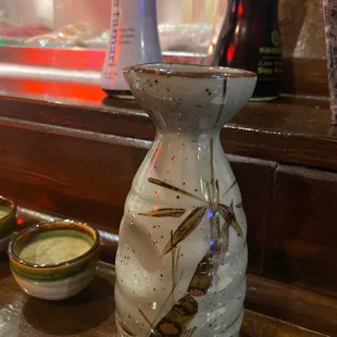 a vase and bowls of sushi