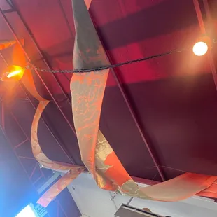 Disgusting ceiling cloth above tables.