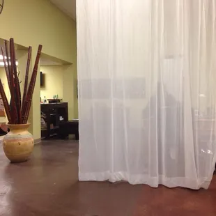 Tall sheer drapes around zen zen create a bit of a magical air while giving some privacy