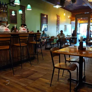 people sitting at tables in a restaurant