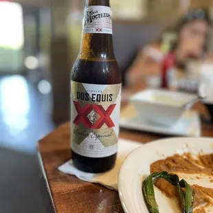 a plate of food and a bottle of beer