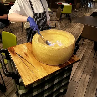 a woman in a chef's uniform preparing food