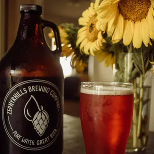 a glass of beer and a sunflower
