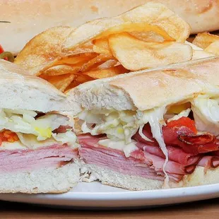 a deli sandwich with a side of chips