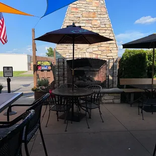 a patio with tables and umbrellas
