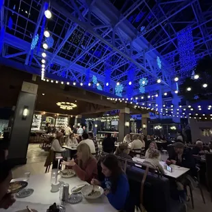 people sitting at tables in a restaurant
