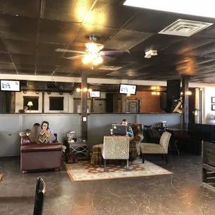 two people sitting on couches in a coffeehouse