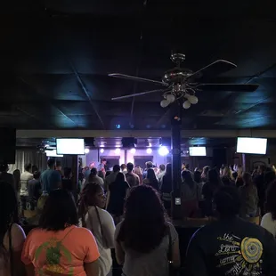 Couple hundred college kids worshiping Jesus and blessing children.