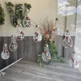 a display of hanging glass vases