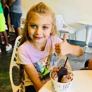 Choc ice cream with rainbow sprinkles, chocolate pocky, and Oreo.