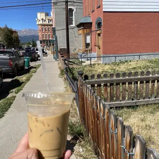 a hand holding a cup of coffee