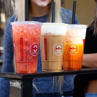a woman holding a tray of drinks