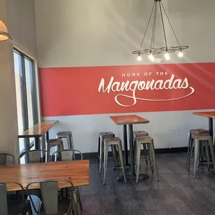 the interior of a restaurant with tables and chairs