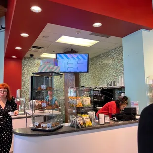 a woman standing in front of a counter
