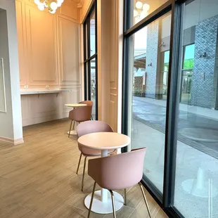 two pink chairs and a round table