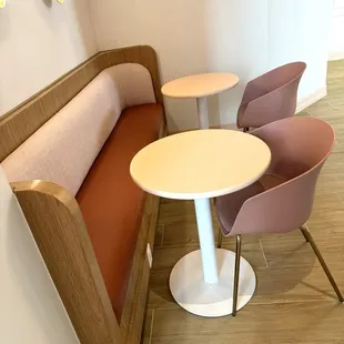 a corner seating area with a table and chairs