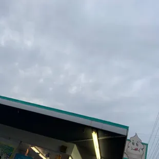 a gas station with a clock tower