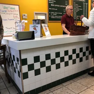 two people standing at a counter