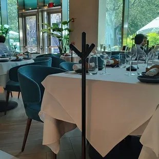 a restaurant with a long table and blue chairs