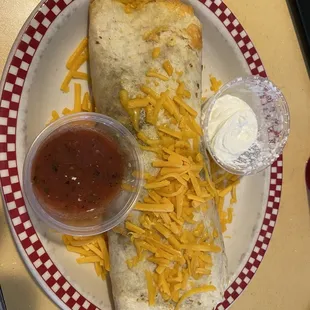 Tex Mex - Hashbrowns, black beans, chorizo, two eggs scrambled with cheese; wrapped in a warm tortilla then topped with salsa and sour cream