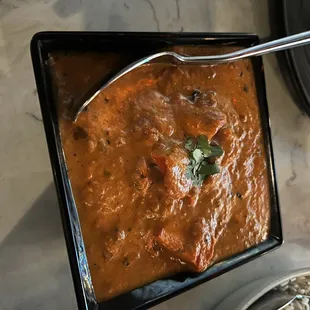 a bowl of soup and a plate of rice