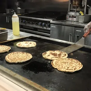 a person cutting pita bread