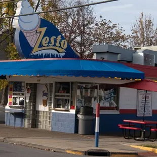 a restaurant with a blue awning