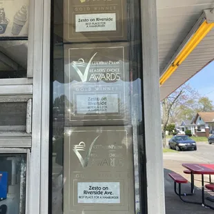 a window with several awards on it