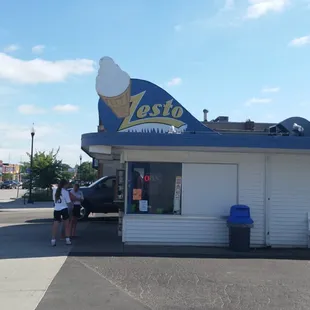 a woman standing in front of the store