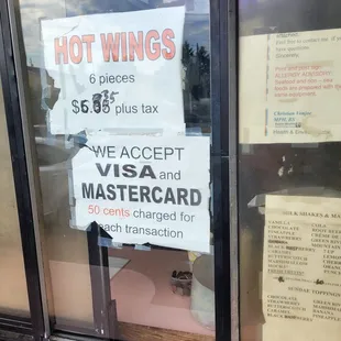 a hot wings sign in a window