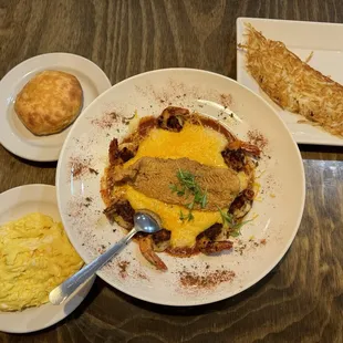 Shrimp and grits, with fried catfish, scrambled eggs, a biscuit and hash browns