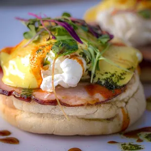  two eggs benedicts on a toasted english muffin