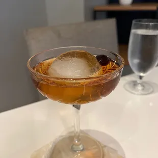 a cocktail in a coupe glass with ice