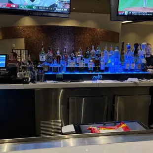 a bar with a lot of bottles on the counter
