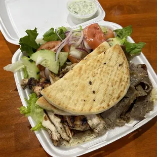 a plate of food with a pita and salad